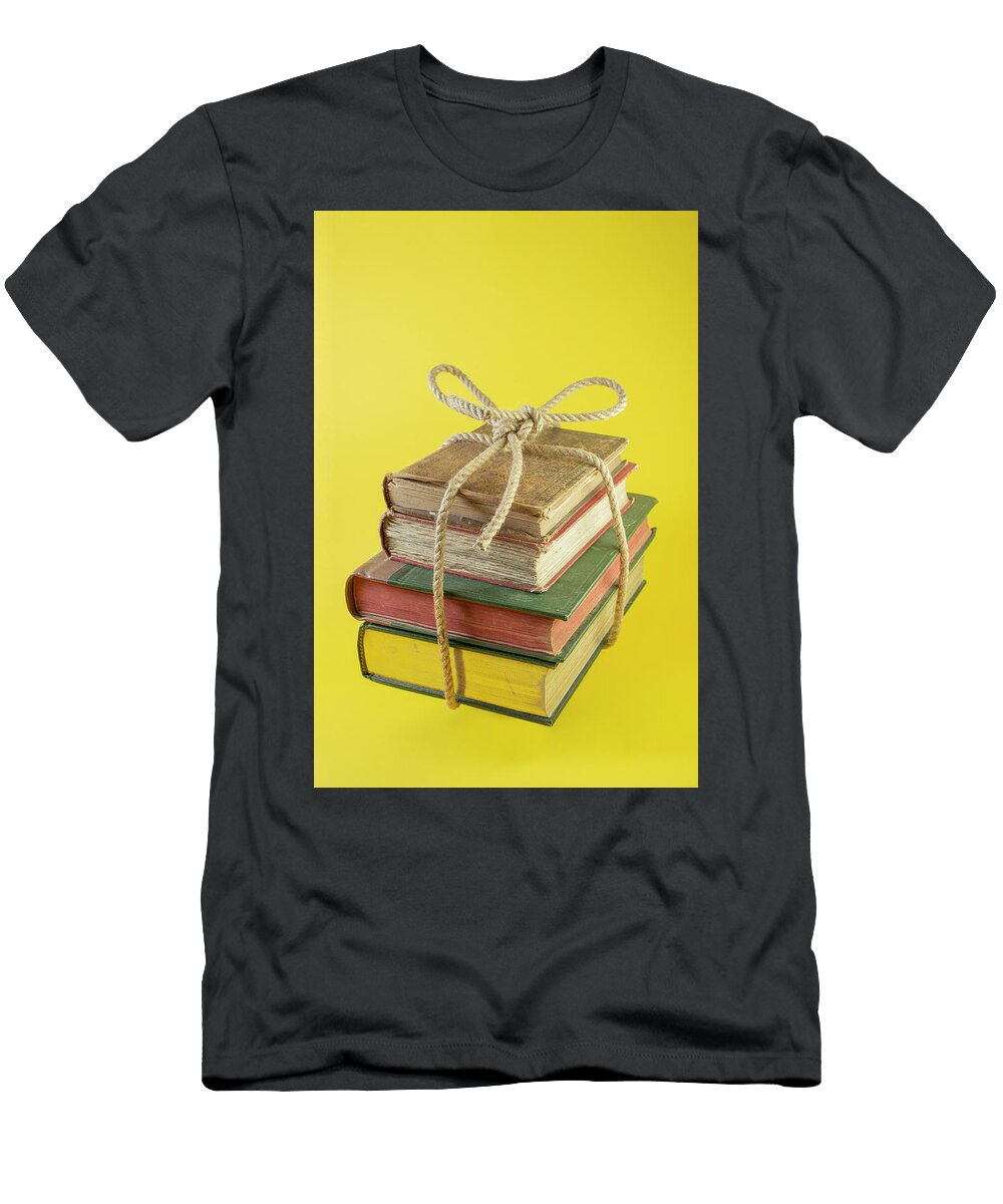 4 Stacked Books Tied with a Jute Rope Levitating on Yellow Dorin Puha T-Shirt