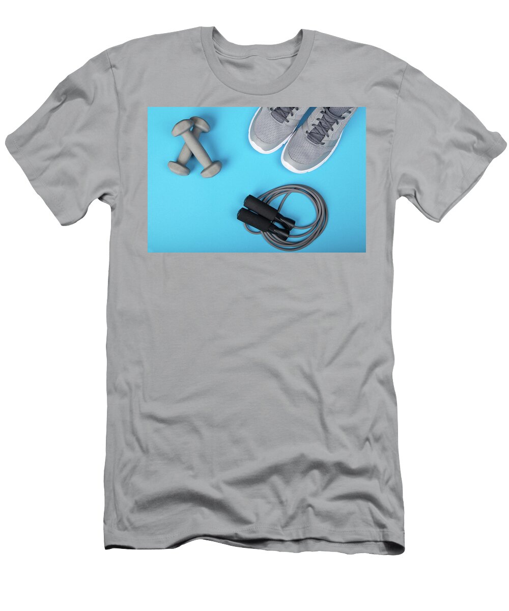 Sport Shoes Dumbbells and Skipping Rope on Blue Background Top View Fitness Sport and Healthy Lifestyle Concept Michael Dechev T-Shirt