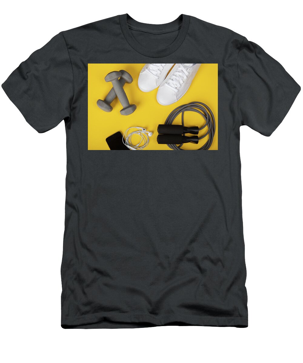 Sport Shoes Dumbbells Mobile Phone and Skipping Rope on Yellow Background Top View Fitness Sport and Healthy Lifestyle Concept Michael Dechev T-Shirt