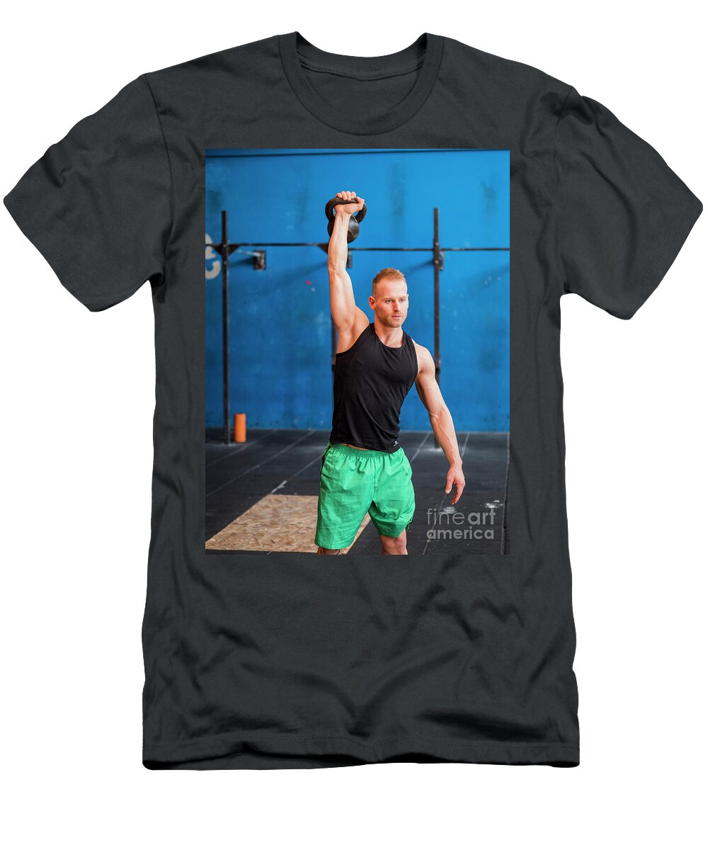 Young Man Exercising with Kettlebells in Gym Stefano Cavoretto T-Shirt
