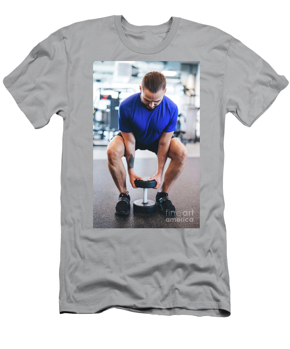 Young Man Lifting Dumbbell At the Gym Michal Bednarek T-Shirt